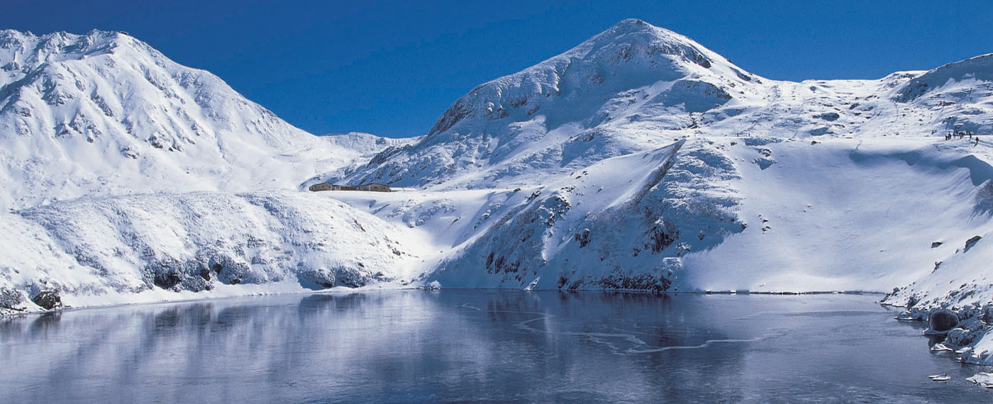 The peak of Mt Tateyama seen reflected in the cobalt blue pond.